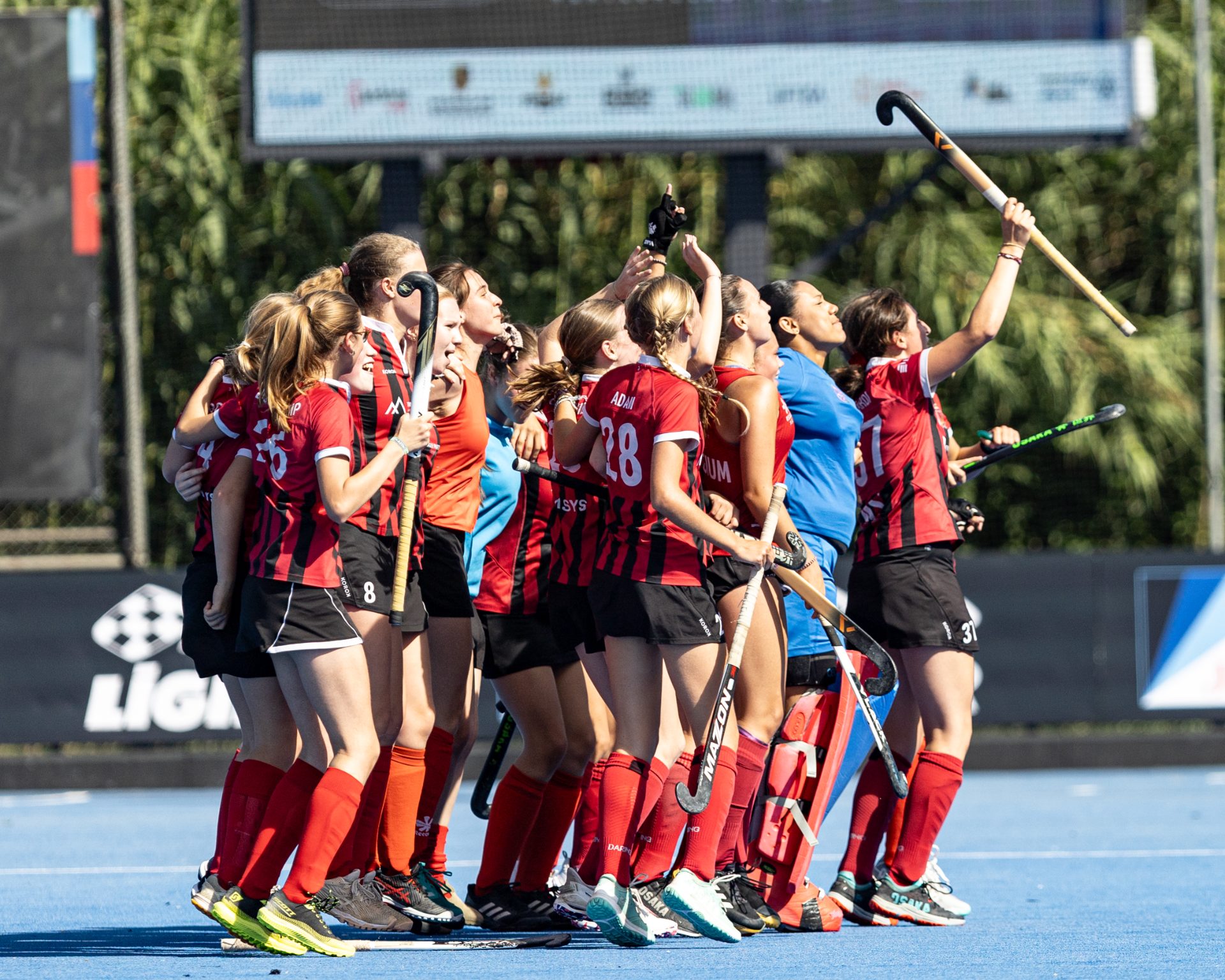 Girls celebrating on the pitch at the Athlos Cup